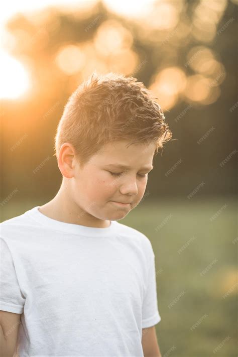 Premium Photo | Upset little american boy looks at camera with confused