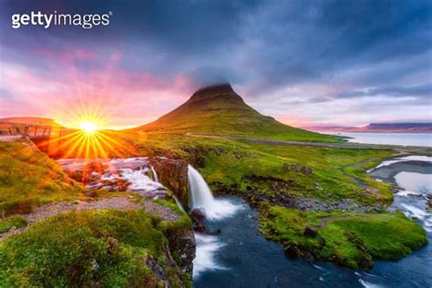 Landscape Of Sunset Shining Over Kirkjufell Mountain With Waterfall And