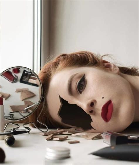 A Woman With Her Face Painted To Look Like She Is Lying On The Table