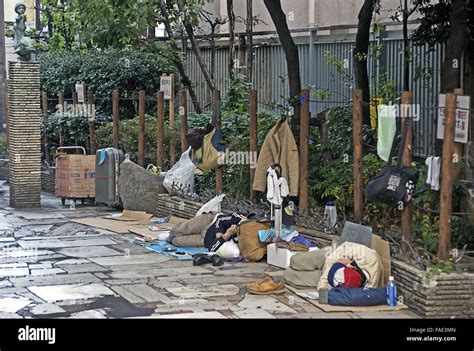 Homeless Japanese Salerymen Sleep Rough On The Streets Of Shinjuku