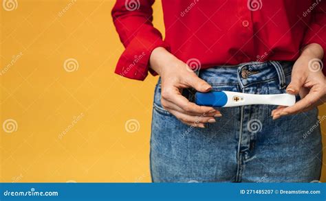 Close Up Of Female Hands Holding A Positive Pregnancy Test The Concept