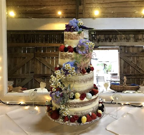 4 Tier Naked Wedding Cake With Butter Cream Icing And Decorated With