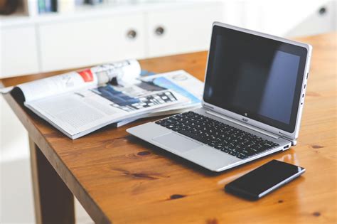 Laptop And Cell Phone On A Wooden Desk · Free Stock Photo