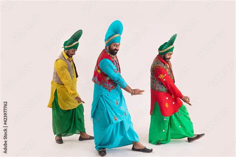 Three Bhangra dancers performing a dance step with hand gestures. Stock ...