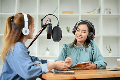 Happy Asian Female Radio Guest Enjoys Talking With A Professional