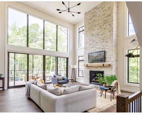 A Living Room Filled With Furniture And Large Windows