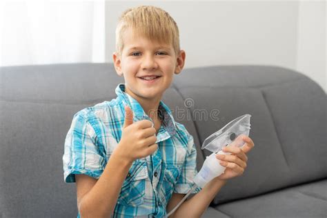 Little Boy Making Inhalation With Nebulizer At Home Stock Photo