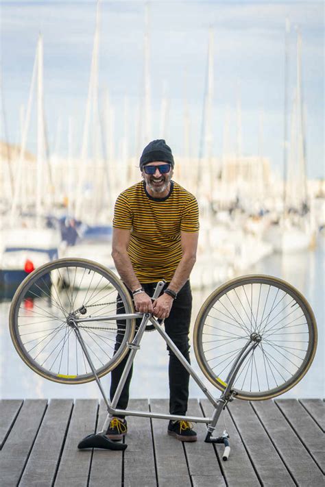 Portrait Of Laughing Mature Man With Fixie Bike Standing On Boardwalk