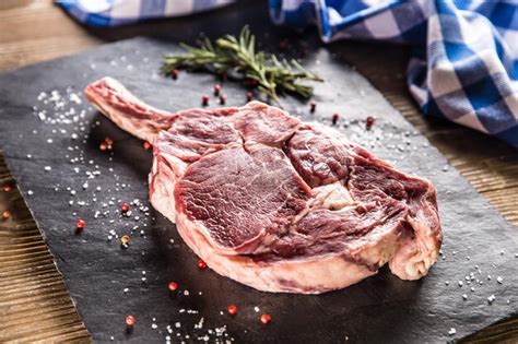 Premium Photo Raw Beef Tomahawk Steak With Salt Pepper And Rosemary