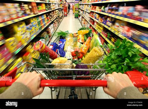 Food Hall Full Shopping Trolley Is Pushed Through A Hallway With Stock