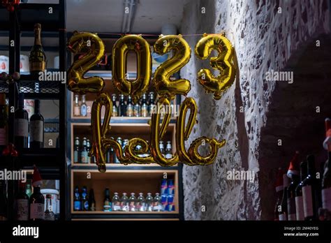 Helium balloons in shape of the year 2023 hangs in a bar in preparation ...