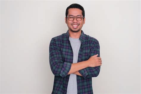 Premium Photo Adult Asian Man Smiling Happy At The Camera With Arms