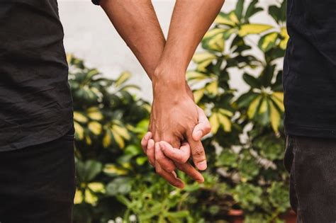 Free Photo | Men holding hands near plants