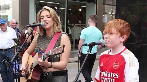 Un Gar On De Ans Se Joint Une Musicienne Dans Une Rue Pour Chanter