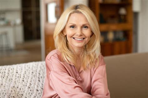 European Mature Woman Smiling While Posing With Arms Crossed Stock