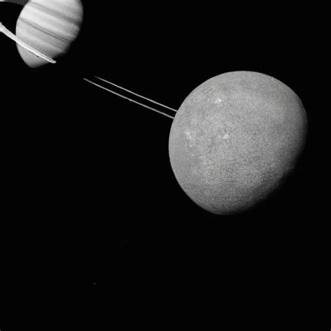 A Photo Of Saturn S Moons Dione And Titan Taken From Openart