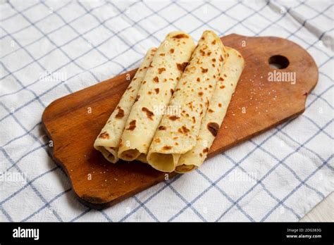 Homemade Norwegian Potato Flatbread Lefse With Butter And Sugar On A Rustic Wooden Board On