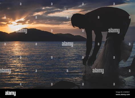 Fisherman and the sunset Stock Photo - Alamy