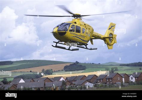 Scottish Ambulance Service Helicopter Above Houses Stock Photo Alamy