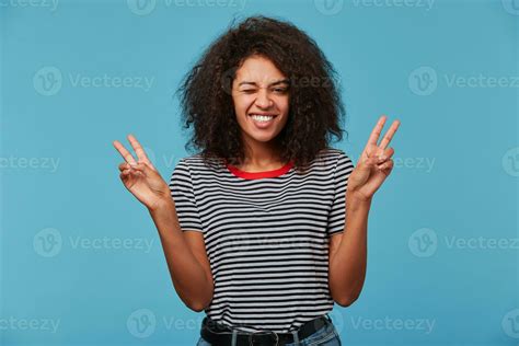 Portrait Of An Excited Young Girl Showing Peace Gesture African