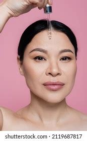 Asian Woman Naked Shoulders Applying Serum Stock Photo