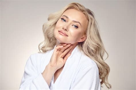 Premium Photo Charming Beautiful Looking Adult Blonde Woman In Her Fifties Wearing A Spa Robe