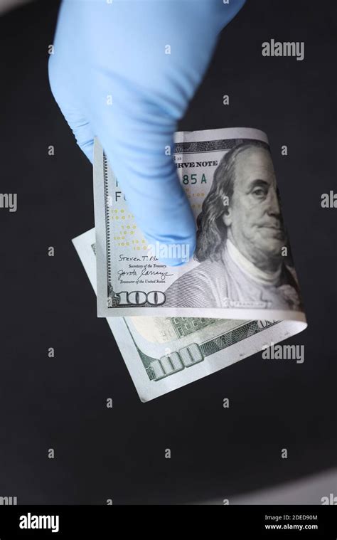 Gloved Hand Holds Hundred Dollar Bill Closeup Stock Photo Alamy