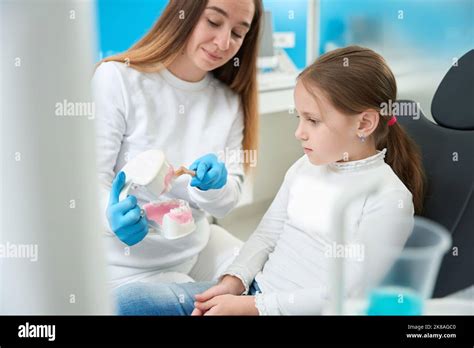 Experienced Pediatric Dentist Teaching Kid Proper Tooth Brushing