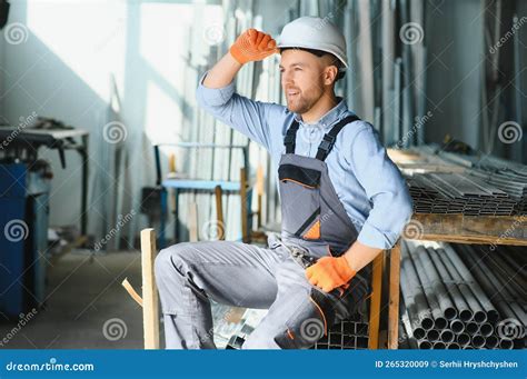 Male Factory Mechanics Or Engineer In Safety Uniforms Are Working On