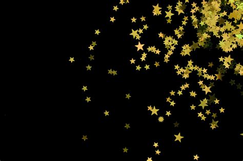 Download Gold Stars Falling On A Black Background