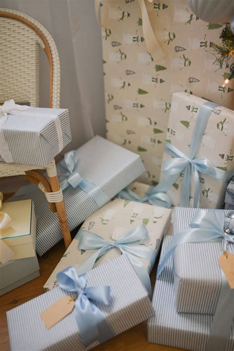 Many Wrapped Presents Sitting On The Floor Next To A Chair