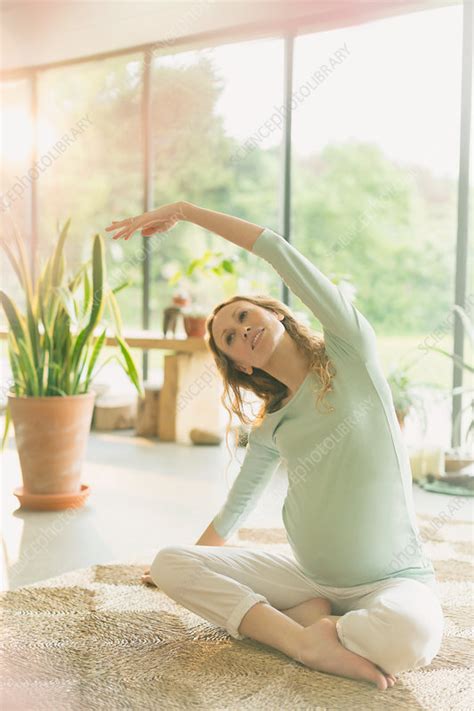 Pregnant woman practicing yoga - Stock Image - F016/5167 - Science Photo Library