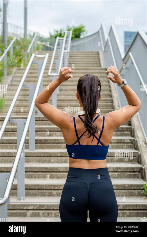 Sporty Woman Standing In Front Of Stairs Stock Photo Alamy