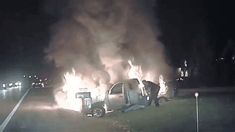 Video Michigan Officer Saves Woman Trapped In Burning Truck