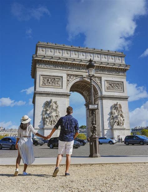 Couple On A Citytrip In Paris Visiting Avenue Des Champs Elysees Paris