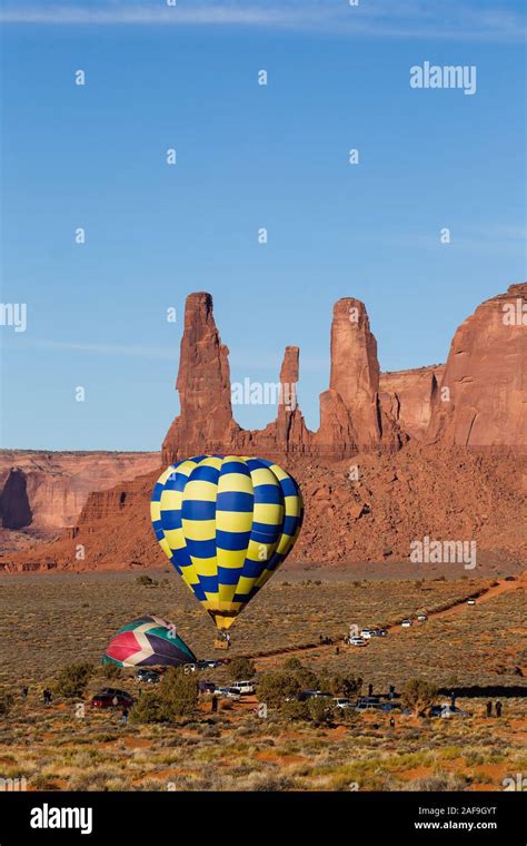 Balloons Launching In Front Of The Three Sisters In The Monument Valley