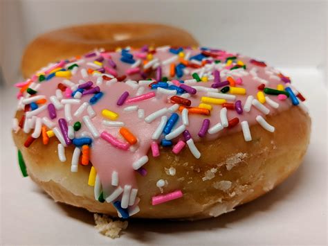 Strawberry Iced Doughnut With Sprinkles And An Original Glazed Doughnut