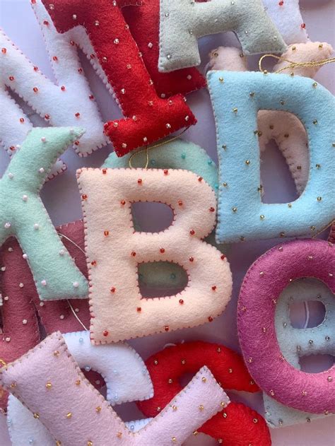 The Letters Are Made Out Of Felt And Sequins