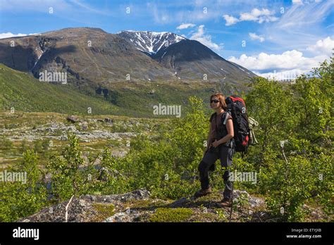 Woman hiking in swedish mountain area, mountains in backround in Stora ...