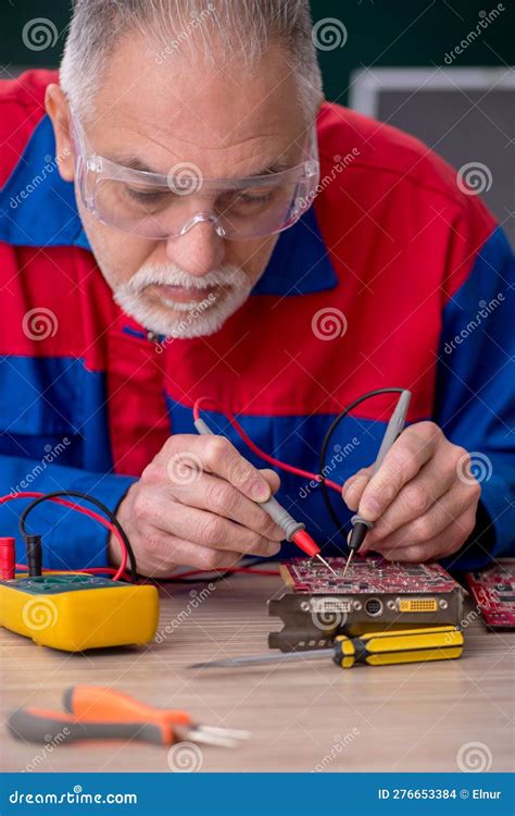 Old Repairman Repairing Computers In The Classroom Stock Photo Image