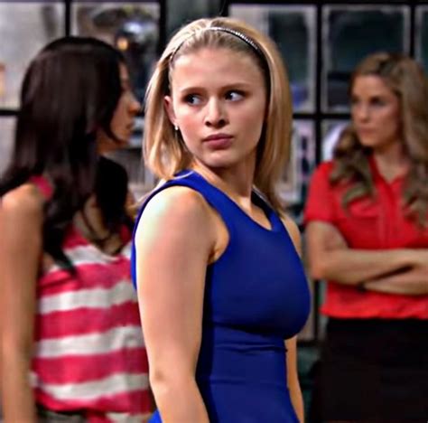 A Woman In A Blue Dress Standing Next To Other Women