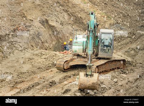 Excavator Digging Soil In The Construction Site Stock Photo Alamy