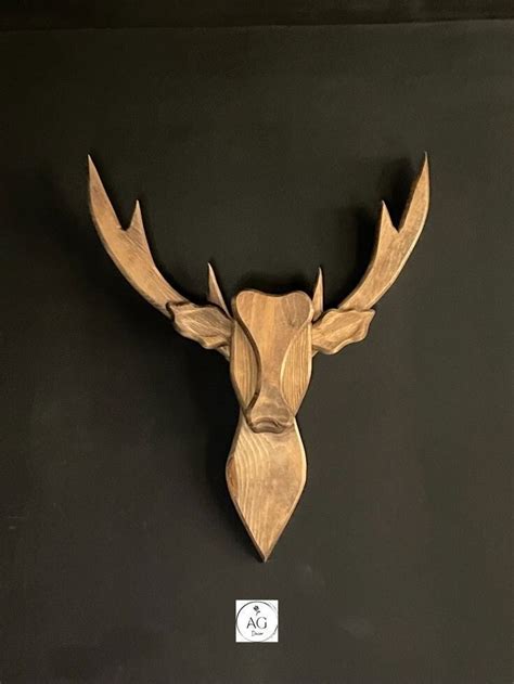 A Wooden Deer Head Mounted On The Wall