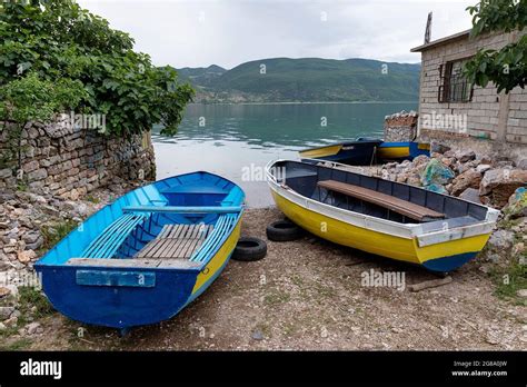 traditional blue  yellow albanian fishing boats moored  shore