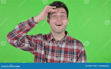 Portrait Of Young Man Looking Around Searching Green Chroma Screen