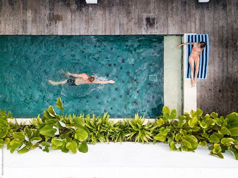 Drone View Of A Couple Relaxing On The Swimming Pool Of A Balinese