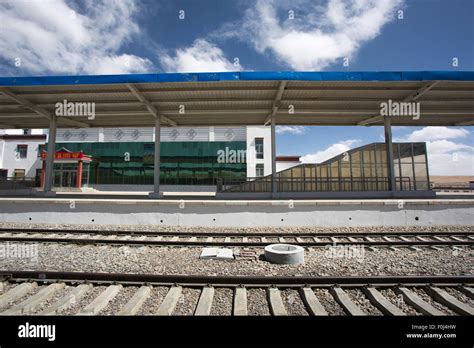 Blue cloudy sky and detail a small and empty Chinese train station in ...