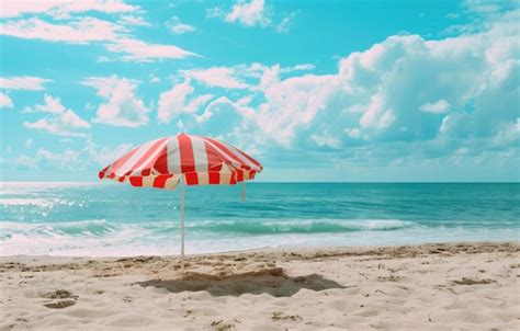 Premium Photo An Outdoor Red And White Striped Umbrella On A Beach