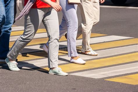 Pedestrians Crossing The Road At A Crosswalk In The City Stock Image