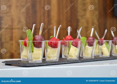 Fruit and Cheese Canapes in Transparent Glasses and Wooden Skewers on a ...